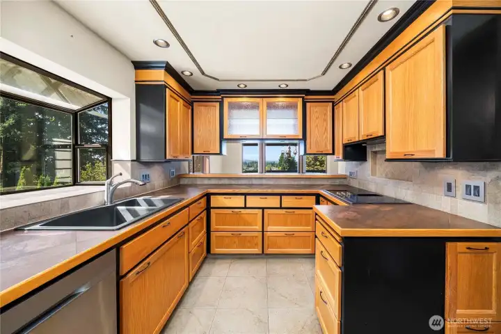 This custom built kitchen with handmade cabinetry built by a master carpenter has tons of creative storage.