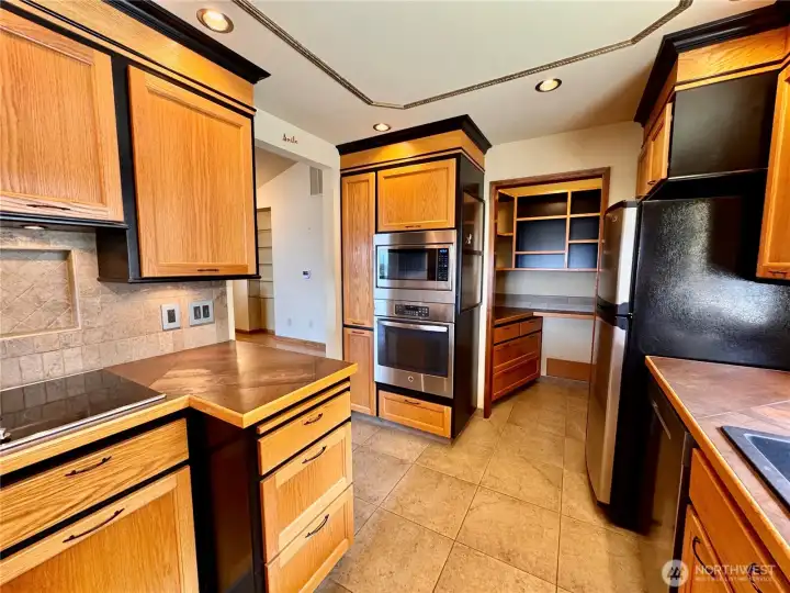 A butlers pantry is found at the back with a sink perfect for wine storage or a coffee bar.
