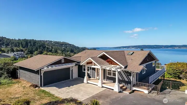 Front of home with paved drive way showing accessible area for ramp if needed. Fully fenced backyard