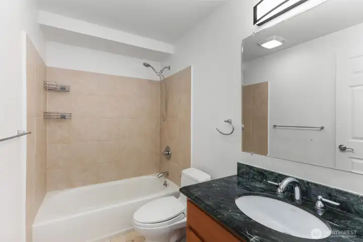 Full bathroom across from laundry area