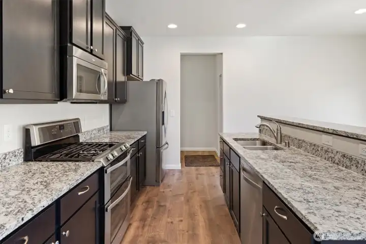 Kitchen features stainless steel appliances and granite countertops.