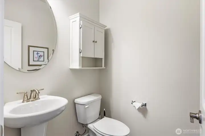 Guest bath offers a stylish pedestal sink for added charm