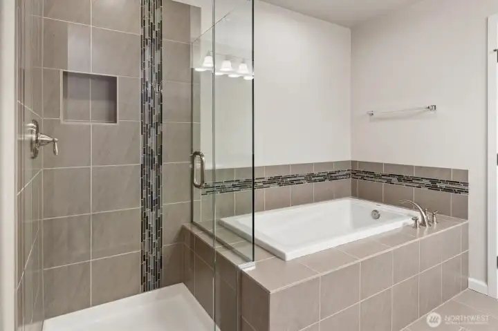 Gorgeous tile surrounds the shower and soaking tub