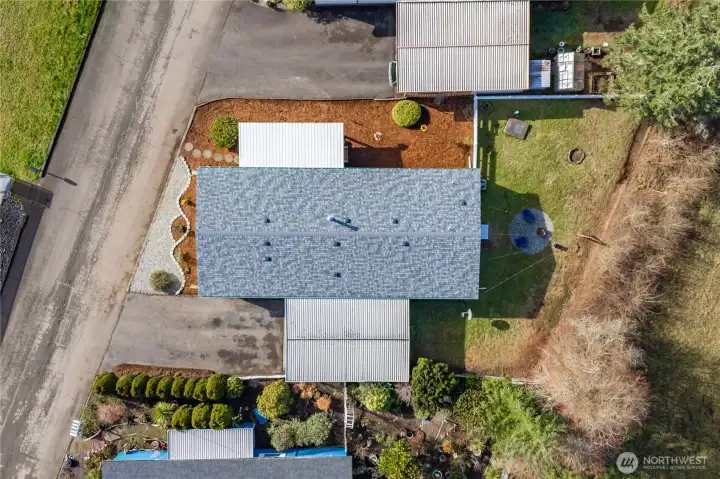 Aerial view showcases the property layout and highlights the BRAND NEW ROOF, offering both standout curb appeal and peace of mind.