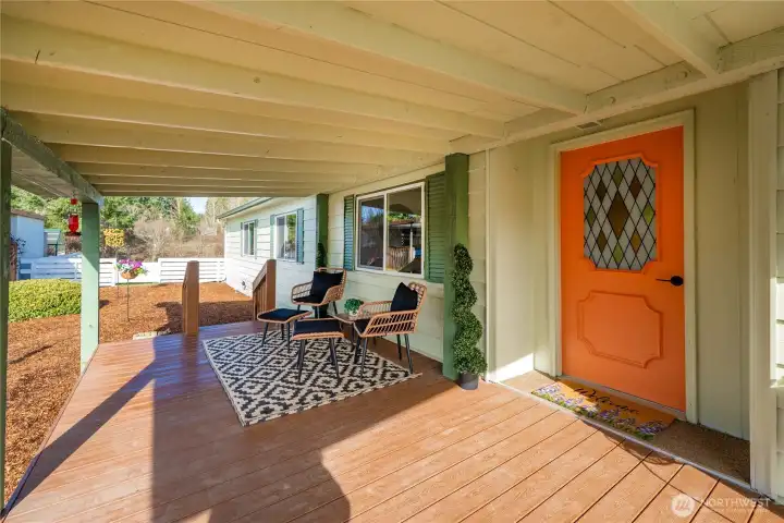 Welcoming covered entry with a bold front door sets the tone and offers a comfortable space to greet guests year-round.