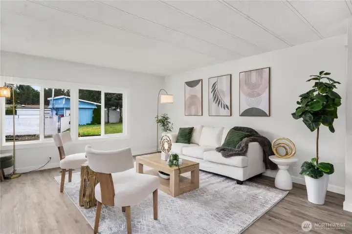 Freshly painted interior, NEW double-paned vinyl windows & NEW LVP flooring create a bright, energy-efficient living space filled with natural light.