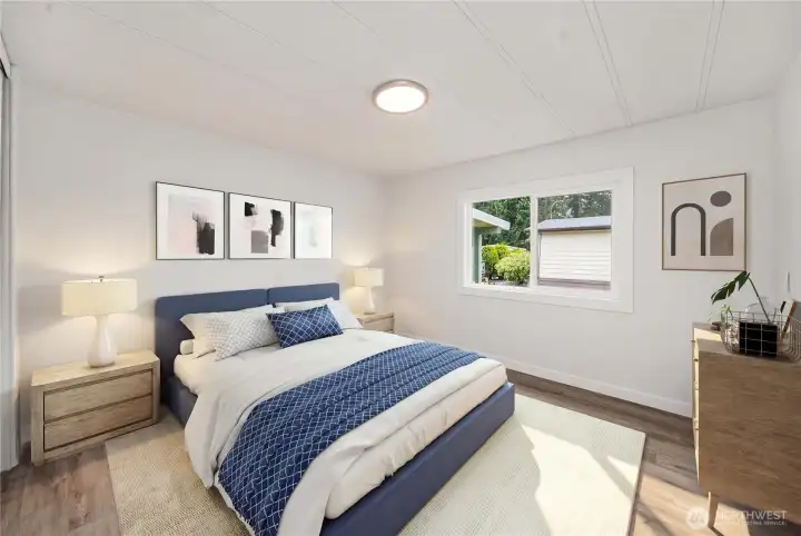 Comfortable guest bedroom offers natural light and a versatile layout for visitors or hobbies.   (photo virtually staged)