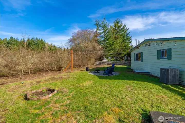Generous fully fenced yard with propane fire pit area creates the perfect setting for gatherings and relaxing evenings.
