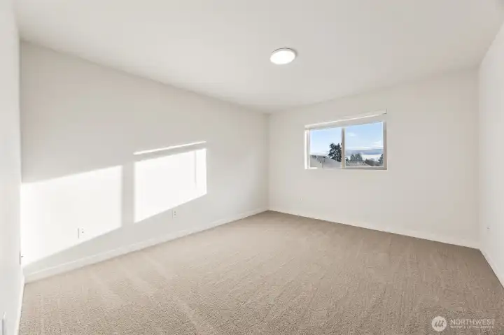Primary bedroom with vaulted ceilings