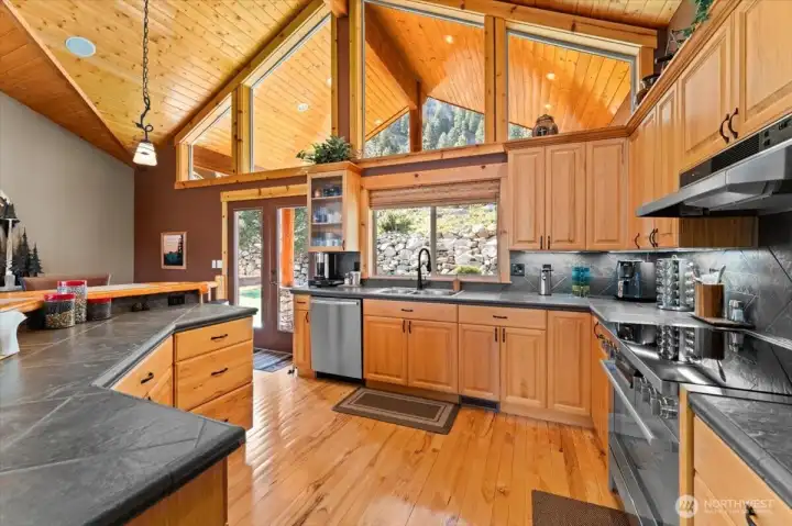 Light and bright kitchen with hardwood flooring and lots of counterspace.