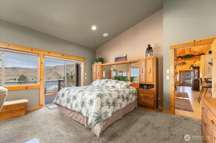 Primary bedroom with Columbia River views and sliding glass doors onto the deck.