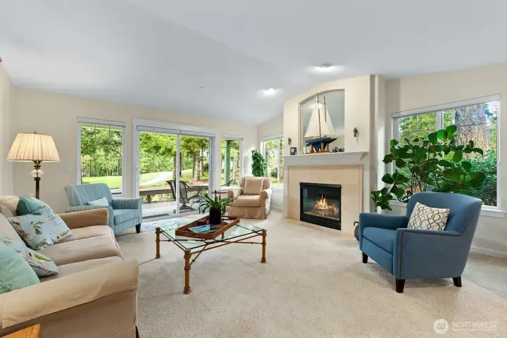 Cozy living room with gas fireplace and sliding doors to deck and patio for seamless indoor-outdoor connection