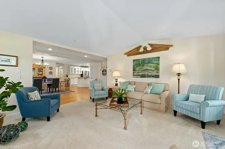 Open floor plan and vaulted ceilings create a spacious living area.
