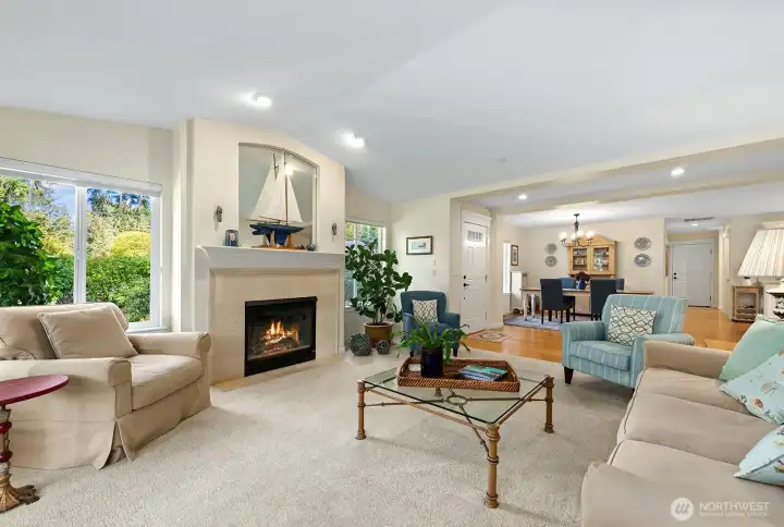 Light-filled living room with large windows framing golf course views
