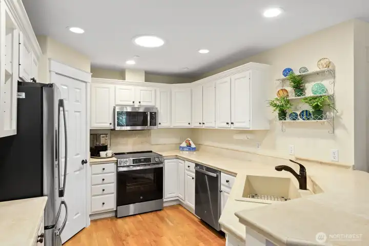 Bright and functional kitchen with ample cabinet space, large pantry, new stainless appliances