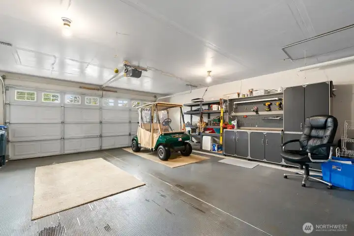 Generous two-car garage offering plenty of storage and convenient space for car and golf cart parking.