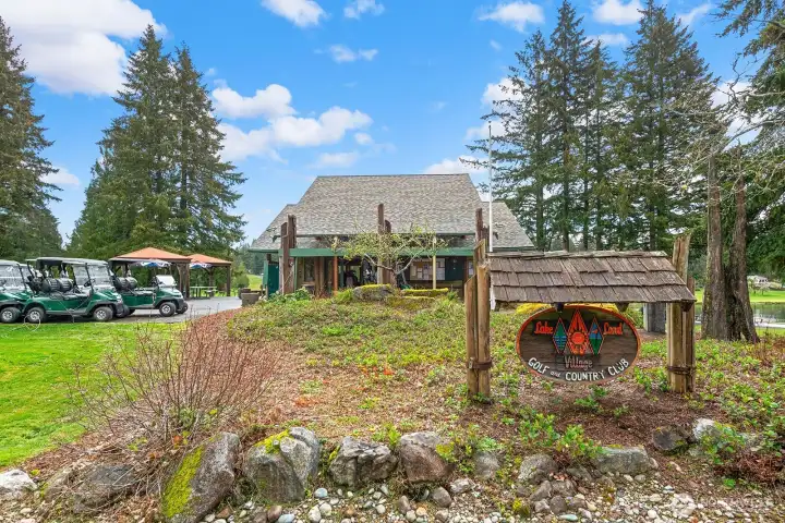 Lakeland Village golf clubhouse featuring restaurant, patio seating, pro shop, and driving range