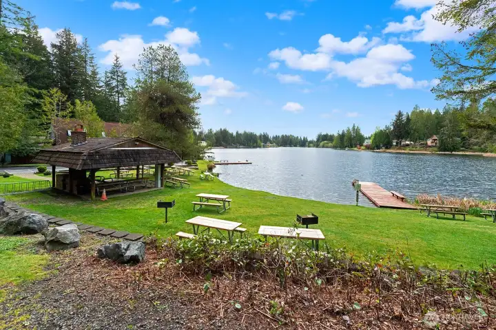Waterfront community beach with designated swimming zone and covered outdoor entertaining space