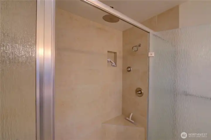 Primary Bath Walk In Shower interior.  There is another regular shower head to the left.