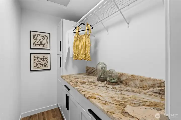 Primary closet, custom built in closet with designer granite countertops