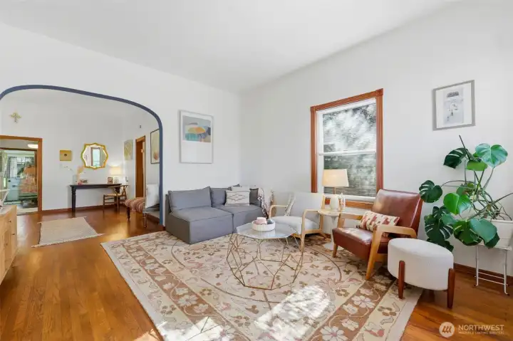 Bright living room with original hardwood floors.