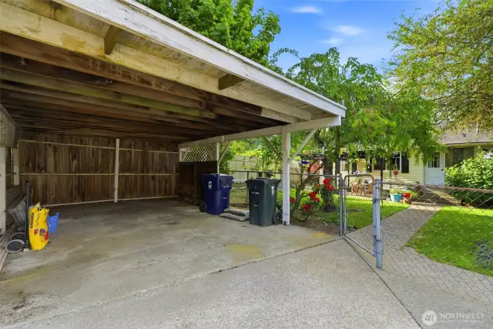 Covered carport behind the house in the alley.