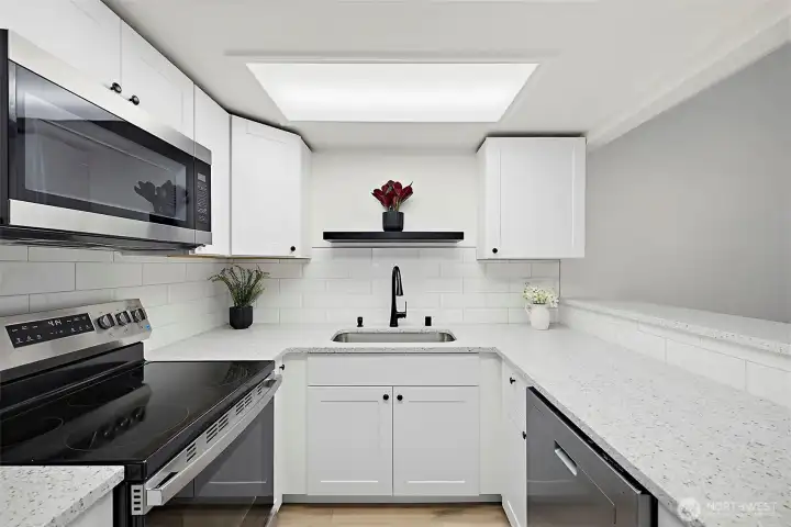 Nice kitchen with quartz countertops and stainless appliances. Nice kitchen with quartz countertops and stainless appliances.