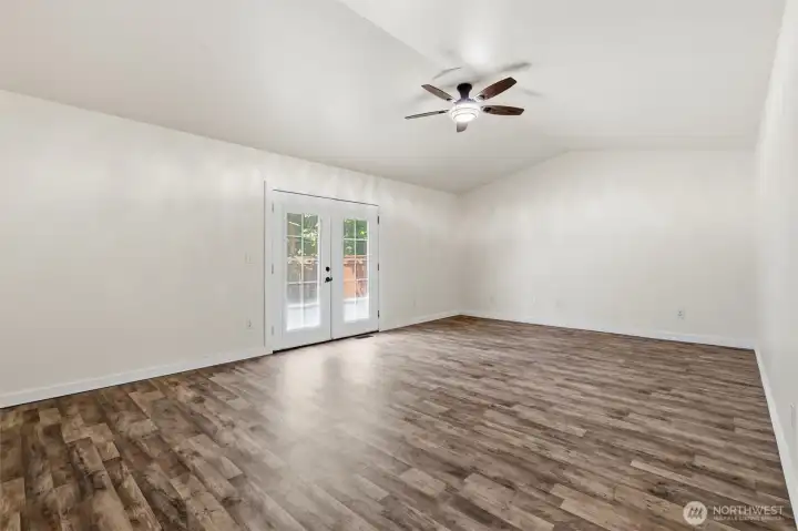 HUGE bonus room with light and ceiling fan and french doors to the backyard