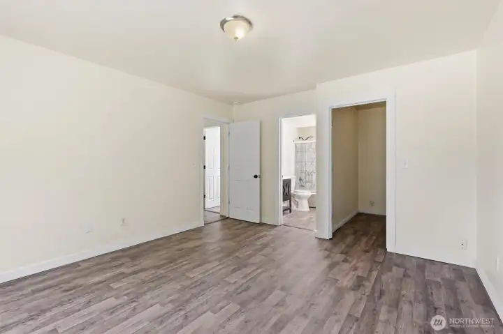 View of bathroom and closet in primary suite