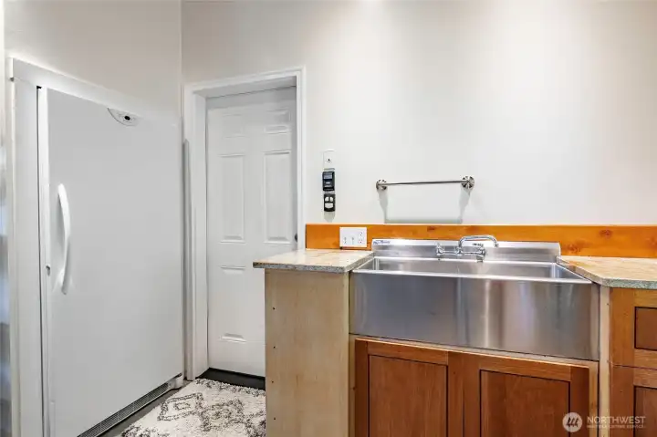 Built in Freezer and sink in the garage, entry door to laundry room and hall to kitchen Built in Freezer and sink in the garage, entry door to laundry room and hall to kitchen
