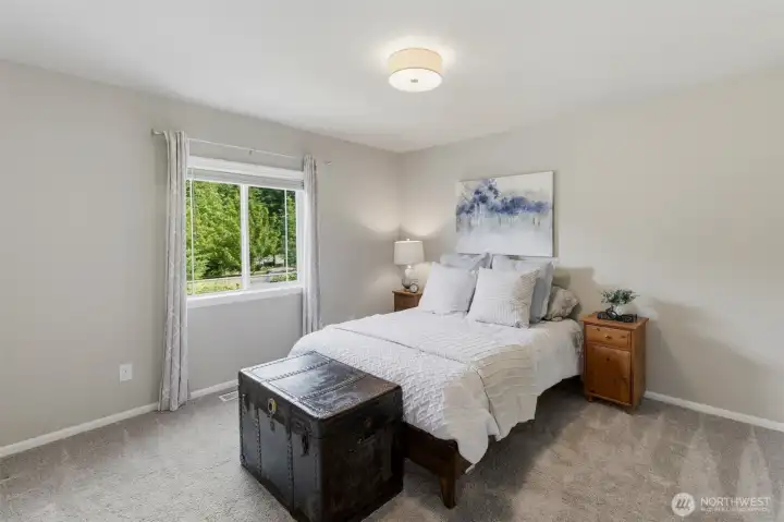 Large bedroom that looks out onto the backyard