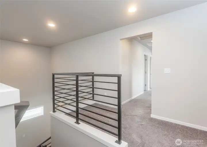 Elegant open wrought-iron railings are featured throughout the home, adding architectural interest while enhancing the open and airy feel of the living spaces.