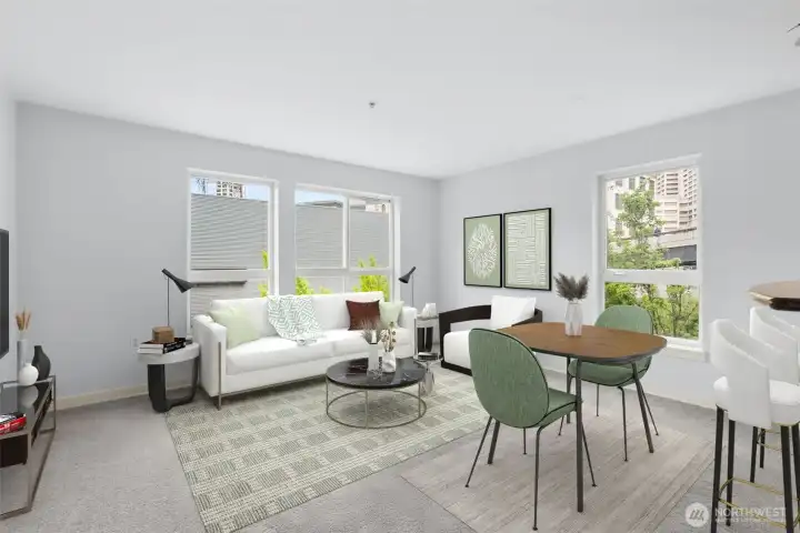The spacious living room features lots of natural light and views of bright green ginkgo trees