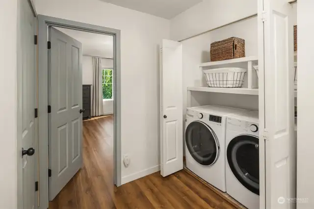 Laundry area with full size washer and dryer that stay with home.