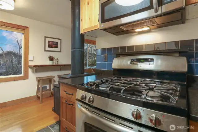 Main (South) home upper level Remodeled kitchen with tile floors, gas range, stainless appliances and bump out for the refrigerator.