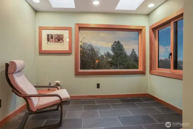 Main (South) home upper level master bedroom suite with a sunroom addition featuring heated floors and southwest light, hardwood floors and custom built shelves and closet.