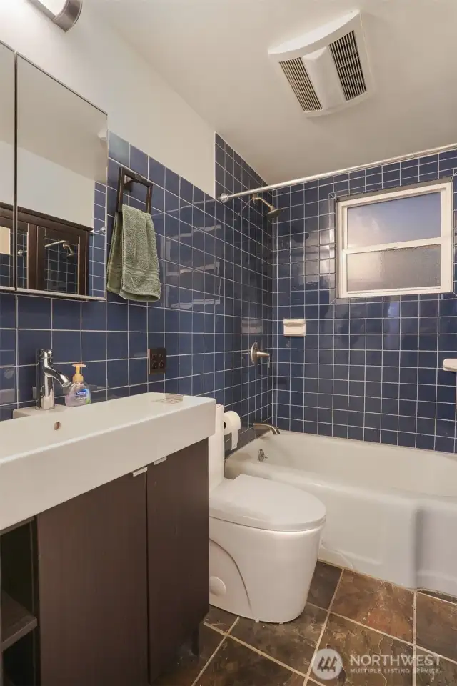 Main (South) home upper level remodeled full tiled bathroom.