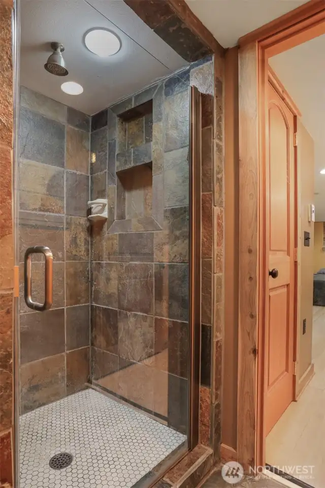 Main (South) home lower level remodeled tiled 3/4 bathroom with heated floors.   Has a separate entry, great income opportunity via vacation rental, housemate, etc.
