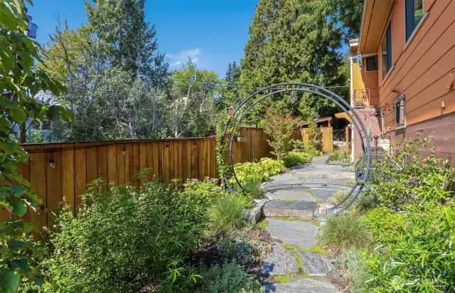 Professionally landscaped west side courtyard with privacy fencing.