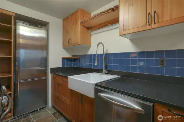 Main (South) home upper level Remodeled kitchen with tile floors, gas range, stainless appliances and bump out for the refrigerator.