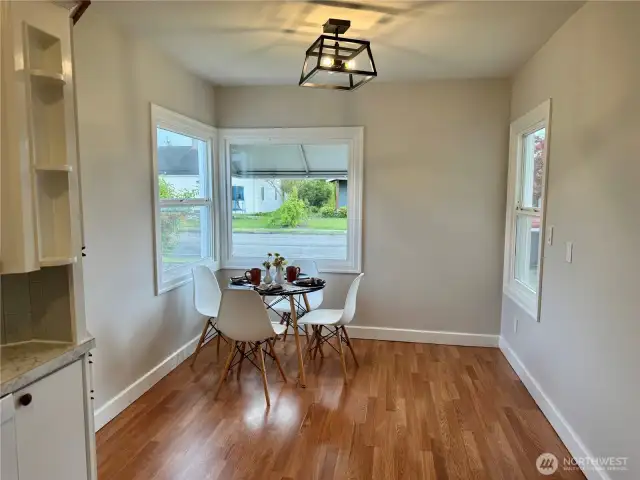 Dining area that is flooded with light from the 3 windows.