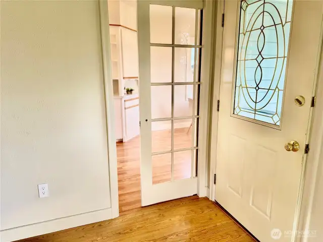 Glass paned pocket door between living room and kitchen.