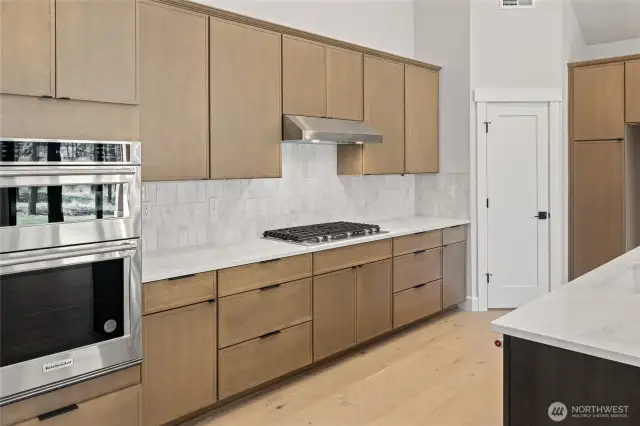 Quartz counter tops with full height backsplash.