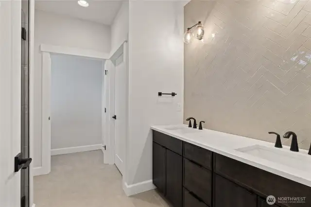 Primary bath has double vanities with undermount sinks.