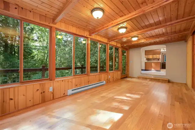 A massive sunroom facing the gorgeous territorial views is flooded with natural light. Through the pass through beyond you'll enter the clean, efficient kitchen space.