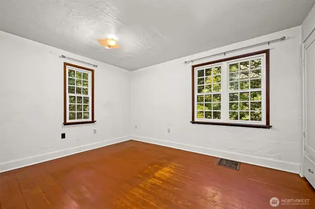 Largest of three bedrooms with vinyl windows, original wood flooring and a built-in closet.