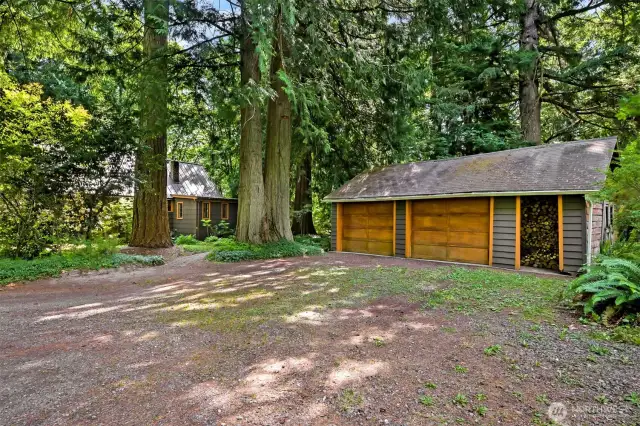 Detached full sized two car garage with additional wood storage.