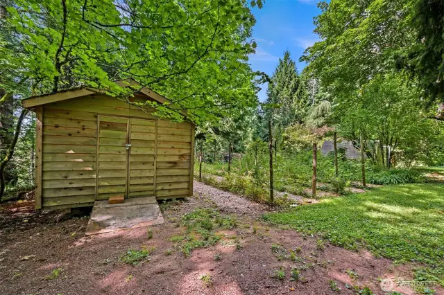 Locked shed with power holds a riding mower and many other landscape tools.