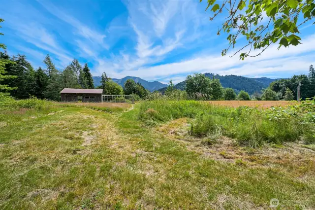 Lower portion of the 27+ acres hosts an additional barn space, power, and a potential space for future development using recorded easement access from Truck Rd.