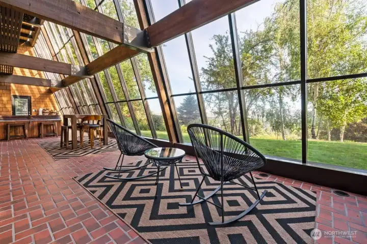 Atrium with floor to ceiling windows, hot tub and yard access